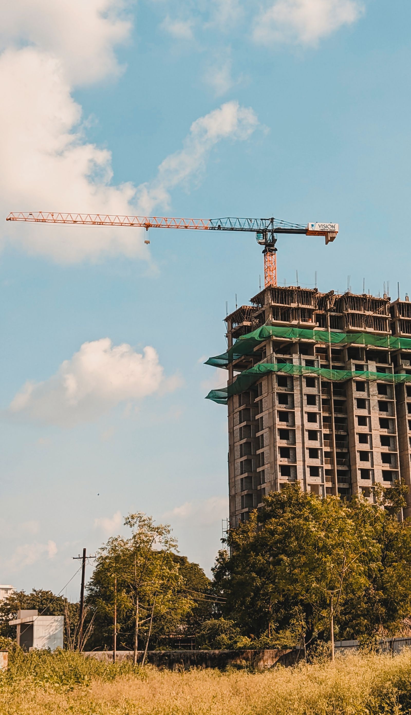 A tower crane above the concrete floors of a building under construction